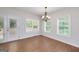 Bright dining room features a contemporary chandelier and an exterior door at 949 Amelia Rd, Locust Grove, GA 30248
