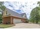 A large two-car garage complementing the brick exterior of the home with well-maintained driveway at 949 Amelia Rd, Locust Grove, GA 30248