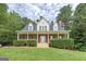 Charming two-story brick home with a welcoming front porch and well-manicured landscaping at 949 Amelia Rd, Locust Grove, GA 30248