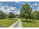 Front view of the home situated on a vast lot with a long driveway, surrounded by lush trees at 949 Amelia Rd, Locust Grove, GA 30248