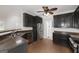 View of kitchen with stainless steel appliances, dark cabinets, and dark countertop at 949 Amelia Rd, Locust Grove, GA 30248