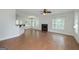 Bright living room featuring hardwood floors, a fireplace, and large windows offering natural light at 949 Amelia Rd, Locust Grove, GA 30248