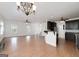 Open living room and kitchen with wood floors, fan, and stairs to the second floor at 949 Amelia Rd, Locust Grove, GA 30248