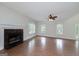 Bright living room featuring a fireplace, ceiling fan, and natural light at 949 Amelia Rd, Locust Grove, GA 30248