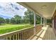 View from the porch overlooking a vast, beautifully landscaped front yard at 949 Amelia Rd, Locust Grove, GA 30248