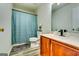Bathroom featuring a toilet, shower with a blue curtain, and a wood cabinet vanity at 121 Wellbrook Circle Ne, Conyers, GA 30012