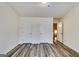 Bedroom featuring gray toned wood-look flooring and two doors leading to closets at 121 Wellbrook Circle Ne, Conyers, GA 30012