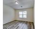 Bedroom featuring gray toned wood-look flooring and a window bringing in natural light at 121 Wellbrook Circle Ne, Conyers, GA 30012