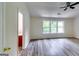 Spacious bedroom with gray toned wood-look flooring and a large window at 121 Wellbrook Circle Ne, Conyers, GA 30012