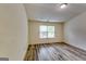 Bedroom with gray toned wood-look flooring and a window bringing in natural light at 121 Wellbrook Circle Ne, Conyers, GA 30012