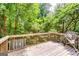 Exterior shot of a wooden deck with greenery in the background at 121 Wellbrook Circle Ne, Conyers, GA 30012