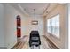 Dining area features hardwood floors, modern chandelier, and a bright window at 121 Wellbrook Circle Ne, Conyers, GA 30012