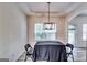 Modern dining room boasts hardwood floors, an elegant chandelier, and natural light at 121 Wellbrook Circle Ne, Conyers, GA 30012