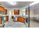 Modern kitchen with stainless steel appliances, wood cabinets, and gray wood-look flooring at 121 Wellbrook Circle Ne, Conyers, GA 30012