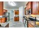 Spacious kitchen with stainless steel appliances, wood cabinets, and gray toned wood-look flooring at 121 Wellbrook Circle Ne, Conyers, GA 30012