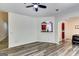 Open-concept living space with hardwood floors and archways into the kitchen and dining area at 121 Wellbrook Circle Ne, Conyers, GA 30012