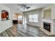 Spacious living room with hardwood floors, fireplace, ceiling fan, and abundant natural light at 121 Wellbrook Circle Ne, Conyers, GA 30012