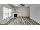 Bright living room featuring hardwood floors, a fireplace, and a modern ceiling fan at 121 Wellbrook Circle Ne, Conyers, GA 30012