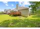 Lush green backyard with a deck and partial view of the home's rear exterior at 20 Knollwood Pl, Covington, GA 30014
