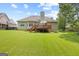 Spacious backyard featuring lush green lawn and a charming deck area at 20 Knollwood Pl, Covington, GA 30014