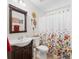Well-lit bathroom featuring a stylish floral shower curtain and a dark wood vanity at 20 Knollwood Pl, Covington, GA 30014