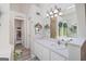 Bright bathroom features a well-lit vanity, an overhead vanity light, and a decorative mirror at 20 Knollwood Pl, Covington, GA 30014