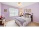 A cozy bedroom with plush bedding, soft lighting, and calming lavender walls at 20 Knollwood Pl, Covington, GA 30014