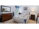 Charming bedroom with floral bedding, wood furniture, and natural light at 20 Knollwood Pl, Covington, GA 30014