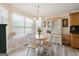 Sunny eat-in kitchen with light wood cabinets, white chairs and good natural light at 20 Knollwood Pl, Covington, GA 30014