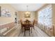 Elegant dining room features a round table, striped walls and floral curtains at 20 Knollwood Pl, Covington, GA 30014