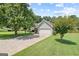 Well-kept home with a two-car garage, manicured lawn, and mature trees at 20 Knollwood Pl, Covington, GA 30014