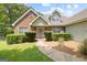 Charming brick home with well-manicured landscaping and a welcoming front entrance with a decorative wreath at 20 Knollwood Pl, Covington, GA 30014