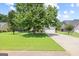 Charming home with well-maintained lawn, mature trees, and a welcoming driveway at 20 Knollwood Pl, Covington, GA 30014
