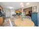 Eat-in kitchen with light wood cabinets, white chairs and nearby dining area at 20 Knollwood Pl, Covington, GA 30014