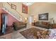 Bright and inviting living room with a high ceiling, showcasing a staircase, comfortable seating, and stylish decor at 20 Knollwood Pl, Covington, GA 30014
