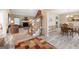 Inviting living room featuring a fireplace, staircase, and seamless transition to dining area at 20 Knollwood Pl, Covington, GA 30014