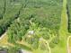 Overhead view of a house surrounded by dense forest and a winding driveway on a spacious lot at 24 Shiloh Church Rd, Carrollton, GA 30116