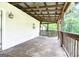Inviting back porch with wooden swing and ceiling, perfect for relaxing outdoors at 24 Shiloh Church Rd, Carrollton, GA 30116