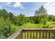 Peaceful backyard view from the deck, overlooking a verdant landscape of trees at 24 Shiloh Church Rd, Carrollton, GA 30116