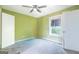 Bedroom featuring green walls, stained blue carpeting, a ceiling fan, and a window for natural light at 24 Shiloh Church Rd, Carrollton, GA 30116