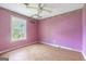 Bedroom with a window and a ceiling fan, providing a bright and airy atmosphere at 24 Shiloh Church Rd, Carrollton, GA 30116