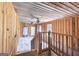 Wood paneled hallway with a wooden staircase, a ceiling fan, and a view into another room at 24 Shiloh Church Rd, Carrollton, GA 30116