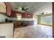 Open kitchen with tile flooring, maroon cabinets, an oven, and connections for appliances at 24 Shiloh Church Rd, Carrollton, GA 30116
