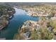 Panoramic aerial view of waterfront homes nestled among trees and docks on a sunny day at 1190 Plantation Dr, Villa Rica, GA 30180