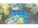 Aerial view showcasing tennis and basketball courts, surrounded by lush trees and a swimming pool at 1190 Plantation Dr, Villa Rica, GA 30180