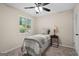 Cozy bedroom with a window view, a ceiling fan, and a neutral color palette at 1190 Plantation Dr, Villa Rica, GA 30180
