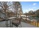Outdoor dining set on wooden deck offers scenic waterfront views at 1190 Plantation Dr, Villa Rica, GA 30180