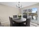 Bright dining area features a modern chandelier, access to a wooden deck, and lake views at 1190 Plantation Dr, Villa Rica, GA 30180