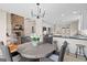 Open dining area with wicker chairs, stone fireplace, and views into the kitchen and living areas at 1190 Plantation Dr, Villa Rica, GA 30180