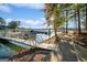 Picturesque waterfront with docks, boats, and a scenic walkway under a sunny sky at 1190 Plantation Dr, Villa Rica, GA 30180